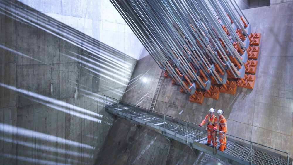 Engineers inspecting structural tension systems during a professional risk assessment