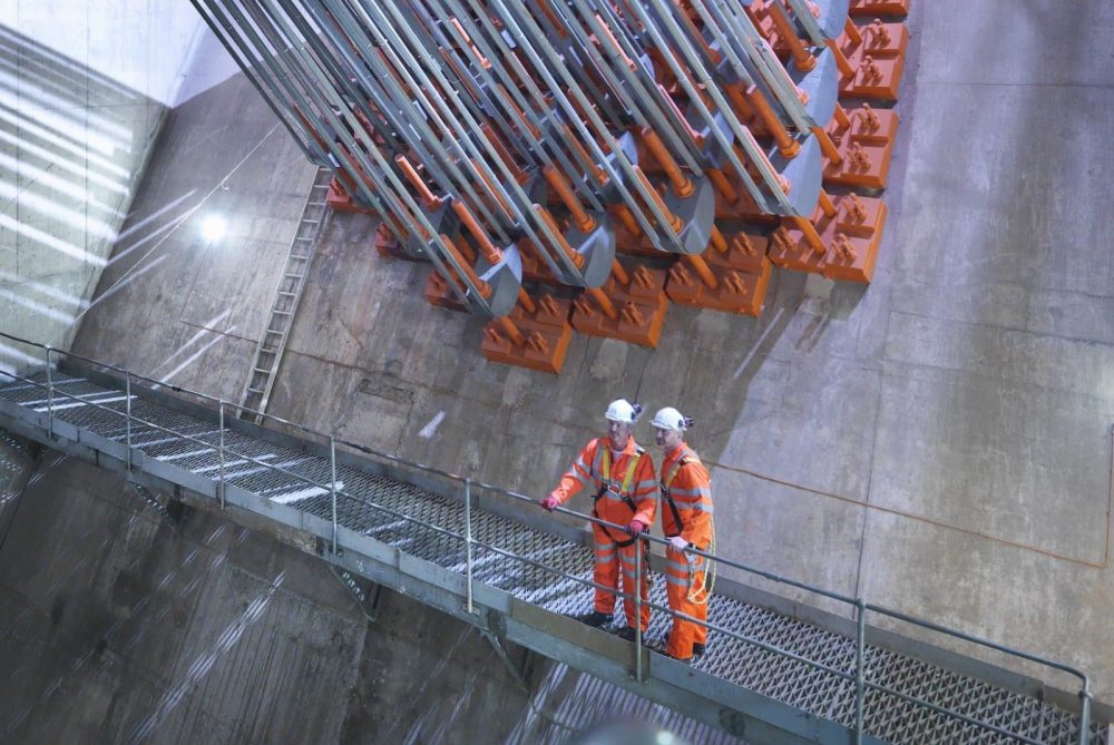 Engineers inspecting structural tension systems during a professional risk assessment